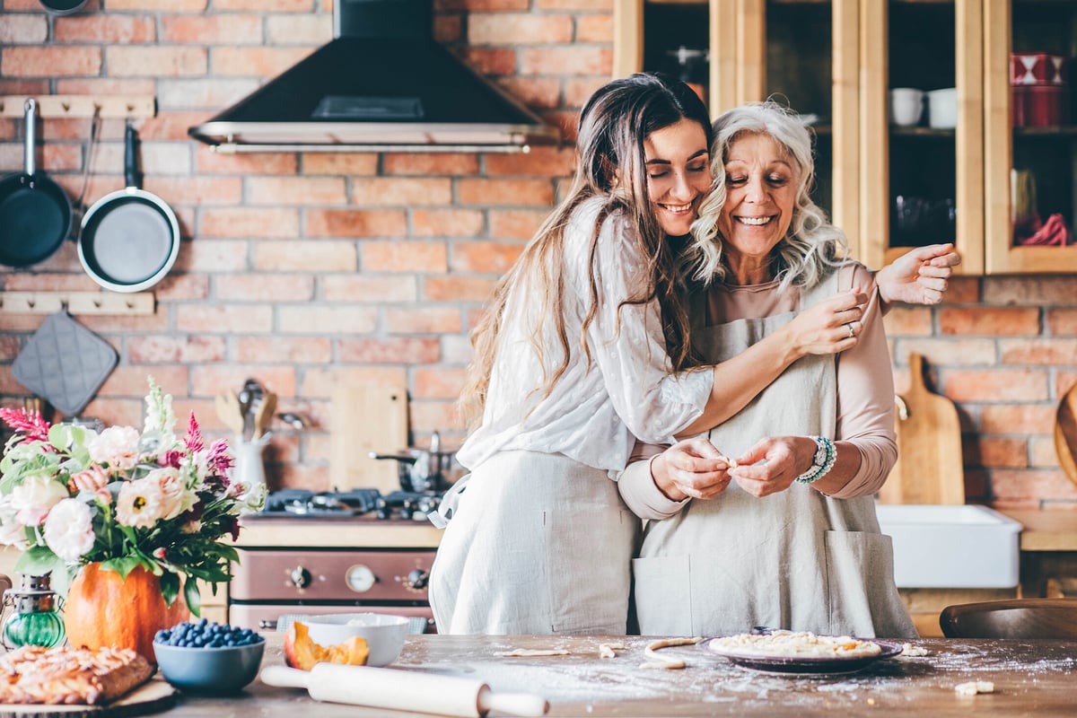 mother daughter hugging in kitchen reduced